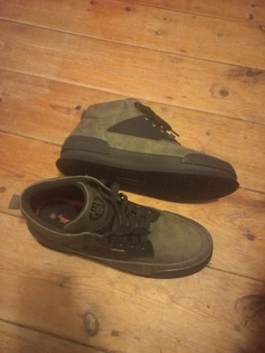 Customer's pair of olive Mazerata Valentino 23 Faux Nubuck Sneakers on a wooden surface.