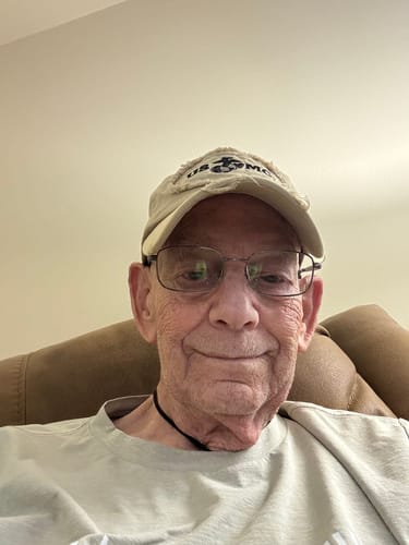 A smiling customer in a photo accompanying their review of the ClarityMax hearing aid.