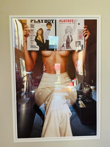 Customer's 'Made to Look' art print in a white frame, displayed in their living room.