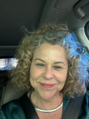 Customer smiling, showing her soft-looking face after using the Koriderm™ Cream Time Reverse.