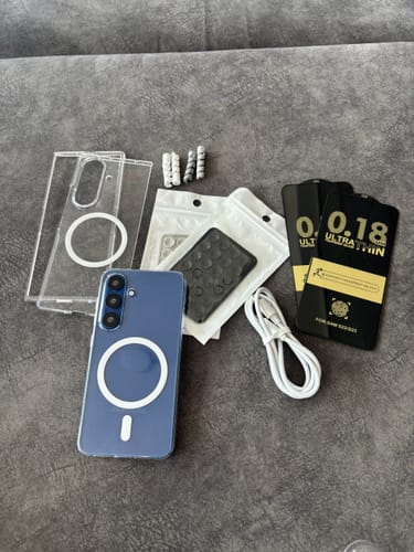 Customer's Anti Yellow Magsafe Clear Case on a blue phone, laid out with a spare case, cable, and screen protectors.