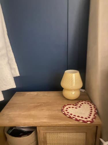 Customer's white swirly Murano Mushroom Table Lamp turned off on a wooden bedroom nightstand.