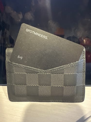 Customer's SPOTMINDERS. Tracking Card shown inside a black checkered wallet.