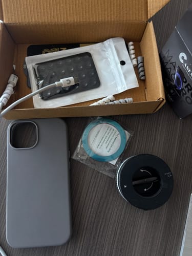Customer's MagPro Magnetic Phone Holder unboxed with a grey phone case, charging cable, and other accessories.