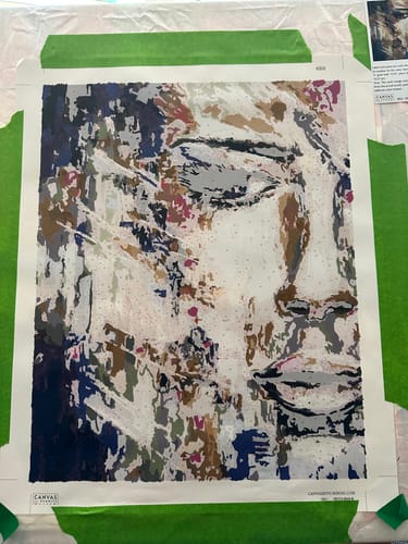 Customer's work-in-progress on 'The Woman Infinity' paint-by-numbers kit, showing the colorful abstract portrait taking shape.