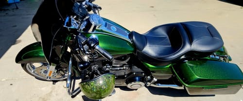Customer's green forged carbon fiber helmet hanging on the handlebars of a matching green motorcycle.