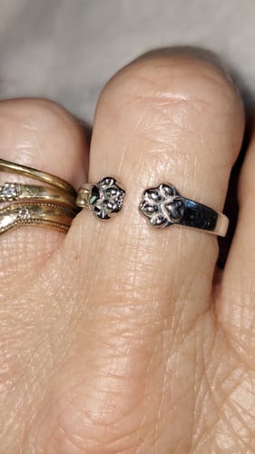 Close-up of a customer wearing the silver Paw Hug Ring on their finger.