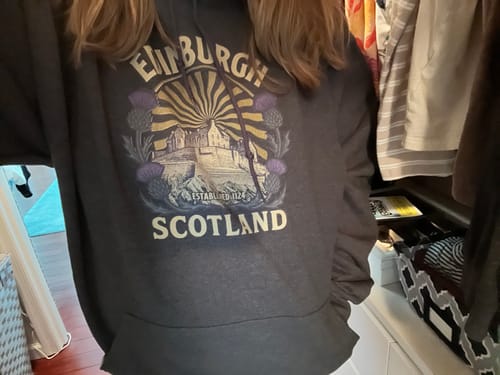 Reviewer showing the back and oversized fit of their gray Edinburgh Scotland Retro Sunburst Hoodie.