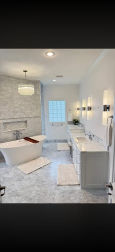 Customer's immaculate bathroom with a freestanding tub and stone tile, showing results of the Bathroom Starter Bundle.