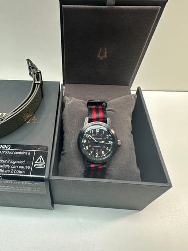 Customer's Bond Scarlet Knight strap on a watch, displayed in a black presentation box.