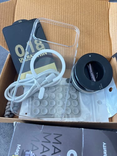Customer's Anti Yellow Magsafe Clear Case inside the shipping box with included accessories.