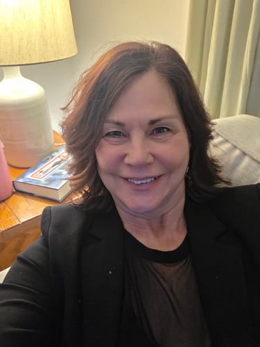 Reviewer smiling, showing glowing skin results after using the Seranova Micro Infusion System.