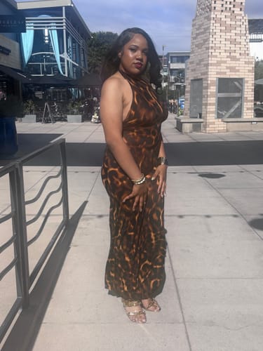 Reviewer showing a side view of the Naked Print Halter Wide Leg Jumpsuit outdoors.