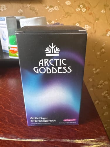 Customer's box of Arctic Goddess Reindeer Organ Superfood standing on a wooden table.