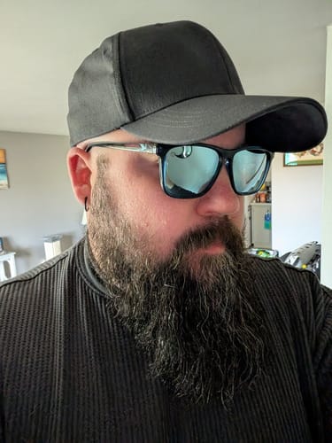 Reviewer showing the comfortable fit of their black Big Flexible Fit Hat.
