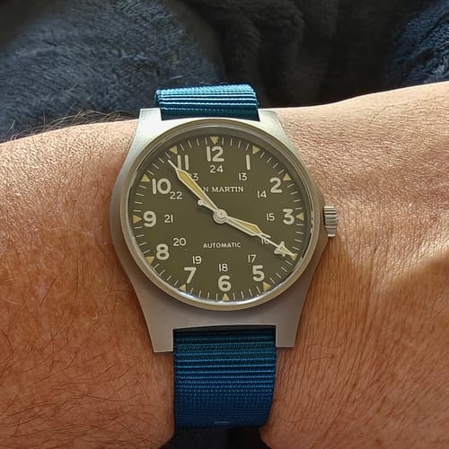 Close-up of a reviewer's wrist wearing a watch with the blue Original - Blu Steel nylon strap.