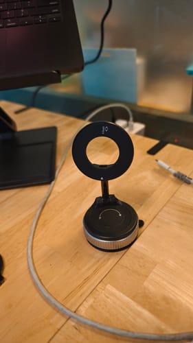 Customer's black 360° MagPro Magnetic Phone Holder by Casence set up on a wooden desk.