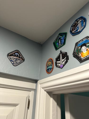 Customer's Artemis II - Collectors Patch displayed on a light blue wall as part of a collection.