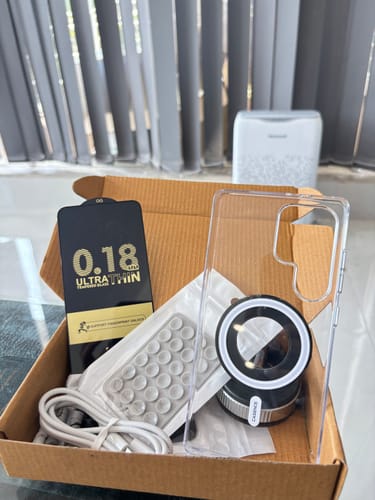 Customer's unboxed Anti Yellow Magsafe Clear Case shown with a magnetic holder, cable, and other accessories in a box.