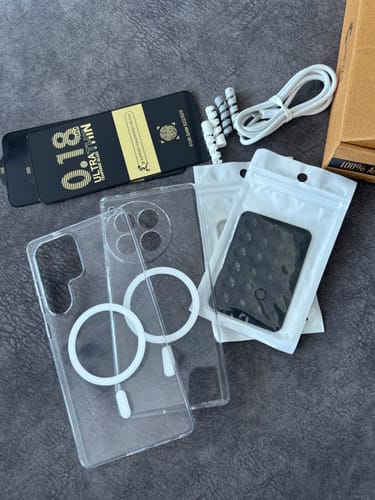 Reviewer's bundle showing two Anti Yellow Magsafe Clear Cases, a cable, Stickypod, and other accessories.