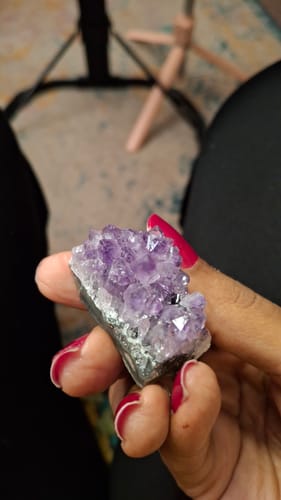 Customer holding a gorgeous purple amethyst crystal cluster from the VIP Crystal Club.