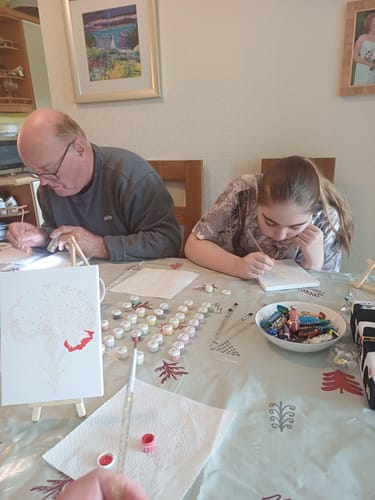 Customers enjoying a family painting session with the 6 Mini Paintings - Flowers Set 2.0 at a table.