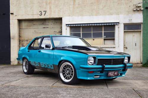 Reviewer's bright blue classic car with a glossy finish from using the Waterless Wash.