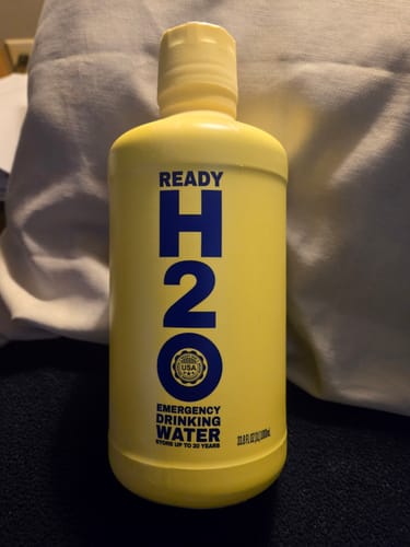 Reviewer's solid yellow bottle of Ready H2O Emergency Drinking Water, standing upright.