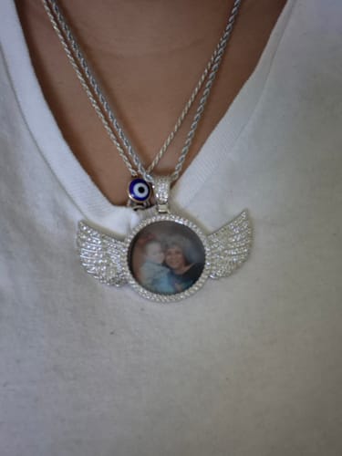 Customer wearing the Diamond Studded Angel Wing Photo Necklace with a personal photo in the pendant.
