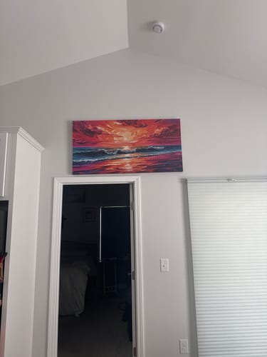 Customer's Coastal Sunset Impasto Wall Art hanging high on a family room wall, above a doorway.