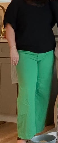 Reviewer showing the fit of the green Eliza Stretchy Trouser Pants with a black top.