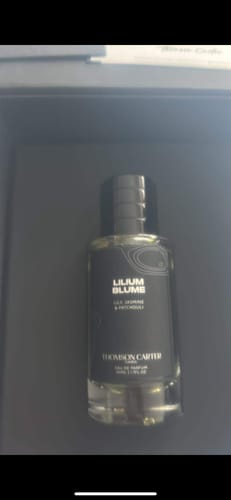 Customer's Lilium Blume | Eau de Parfum bottle with a black label, sitting inside its box.