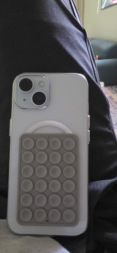 Customer's Anti Yellow Magsafe Clear Case on a white iPhone, with a grey MagSafe accessory attached.