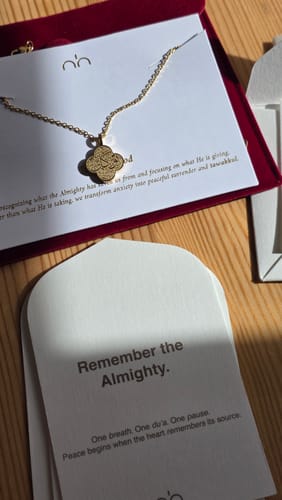 Customer's gold Trust in God Necklace in its fancy red packaging box, shown with accompanying inspirational cards.