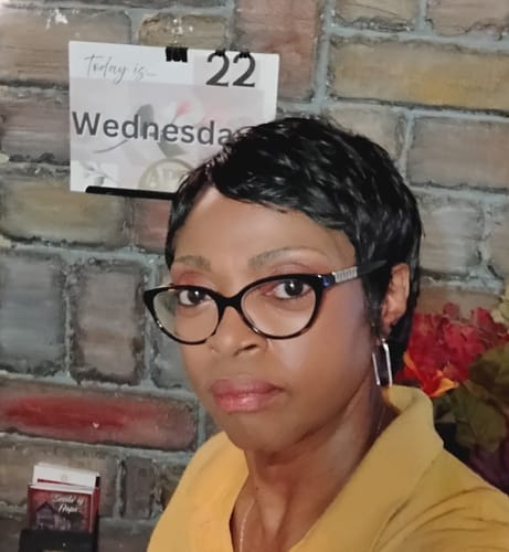 Reviewer wearing the short, black Vanessa Vixen HH CHI wig in a pixie style.