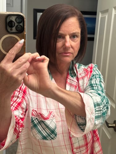 A reviewer's face in a 'before' photo prior to using Koriderm™ Time Reverse Cream.