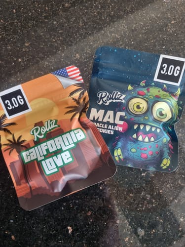 Customer's sealed, orange packaging for California Love THCA Flower shown next to another Rollz product bag.