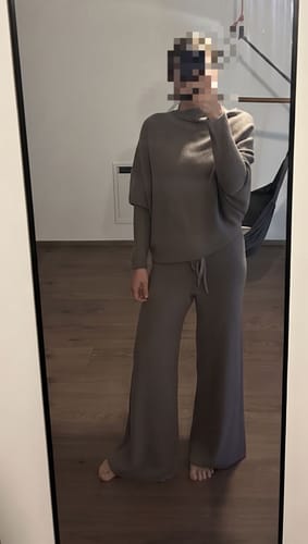 Reviewer in a full-length mirror view wearing the mink Asymmetric Draped seamless knit top with matching wide-leg pants.