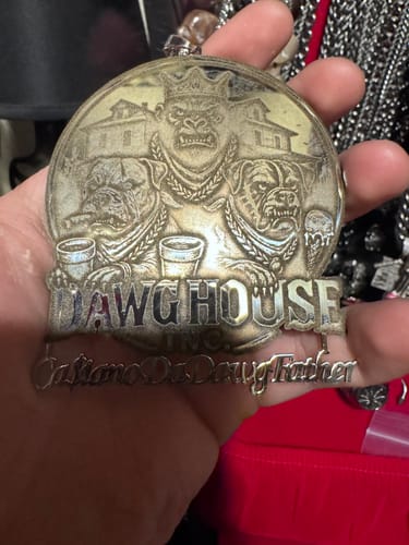 Reviewer holding their large custom logo engraved pendant, highlighting its size and detailed design.