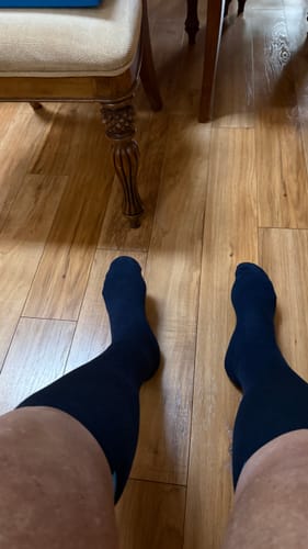 Reviewer's first-person view of their legs in the dark Performance Eucalyptus Compression Socks.