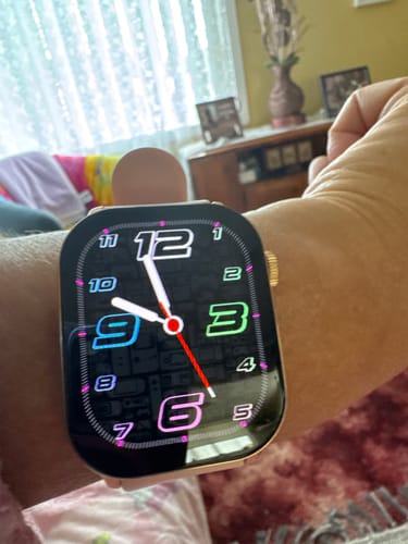 Customer wearing the GARD PRO 2 smartwatch with a colorful, stylized analog face on their wrist.