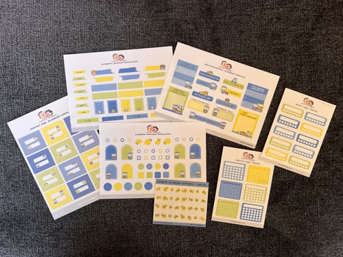 Customer's Blueberry Lemonade Journaling Extras Sticker Set with all seven sheets fanned out on a dark surface.