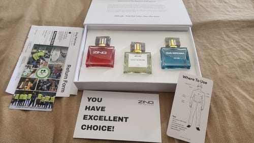 Reviewer's OUD Supreme BUNDLE showing the three fragrance bottles in their open white presentation box with included cards.