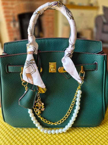 Reviewer's green Warkin Bag accessorized with a patterned scarf on the handle and decorative chains.