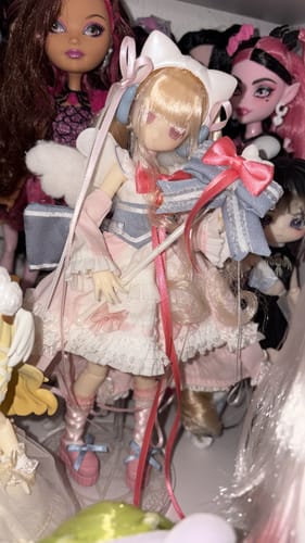 Partial view of a reviewer's Transform Electrical Street action figure, with blonde hair obscuring its face.