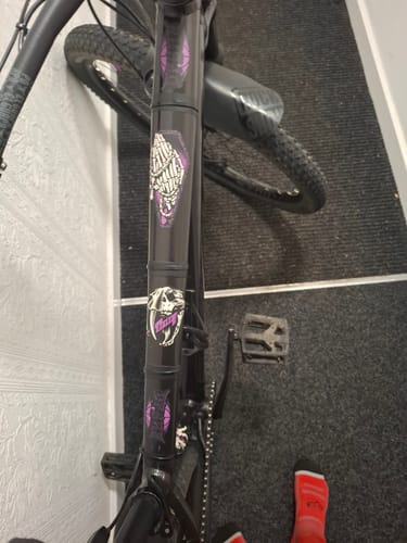 Reviewer's Lucky Dip stickers with graphic designs applied to a black bike frame.