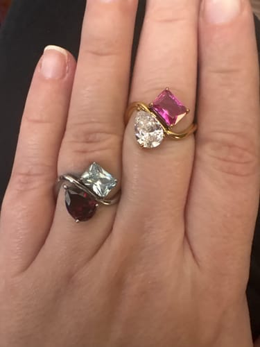 Reviewer wearing two Navae Birthstone Rings on one hand, showing both gold and silver-tone finishes with unique stone colors.