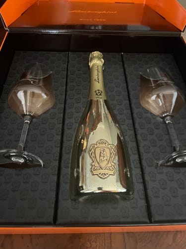 Customer's Lamborghini sparkling wine gift set with a gold bottle and two glasses in a box.