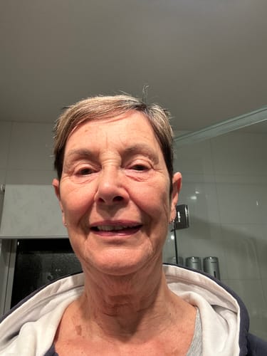 Reviewer smiling in a selfie-style photo.