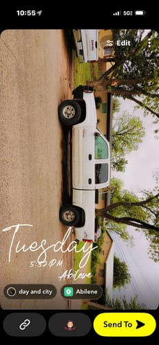 Reviewer's white truck, shown leveled after installing the front leveling lift kit.